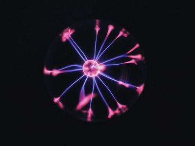 Electric purple sparks on a deep black background